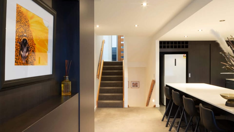Breakfast bar.   Also showing stairs up to front door and stairs down to lower bedrooms.