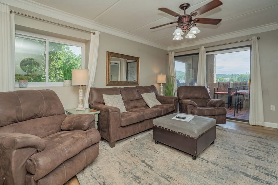 Settle into this inviting living room where plush seating and gentle natural light create your perfect retreat. Step onto the balcony to take in the peaceful mountain views.