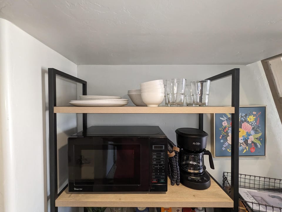 Dishes, microwave, and coffee pot