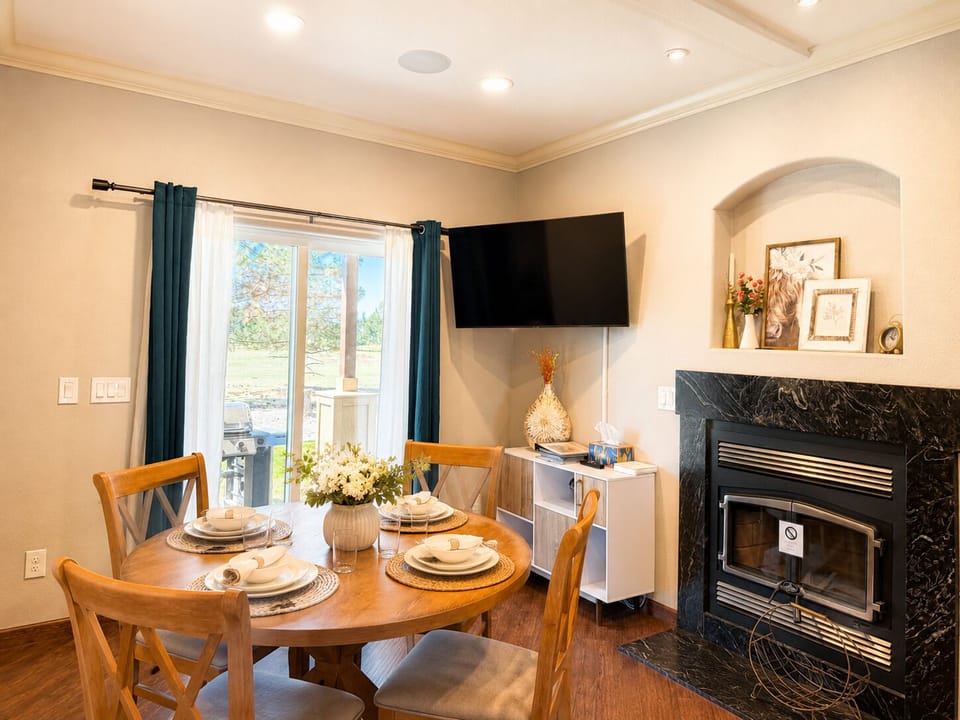 Experience the charm of intimate dining in our dining room. Set against a backdrop of soft lighting and inviting decor, this space invites you to share laughter and delicious meals with loved ones. (Indoor fireplace cannot be used)
