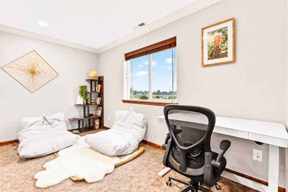 Find your perfect balance of productivity and relaxation in our workspace, featuring a height-adjustable desk and cozy reading nook. Whether you're diving into work or escaping into a good book, this versatile area caters to your every need.
