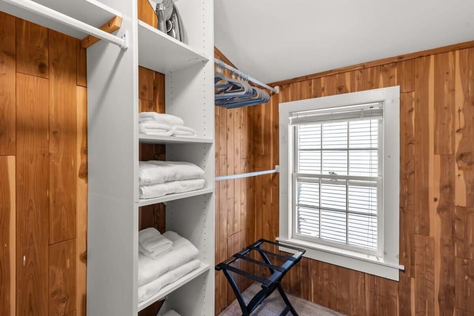 Main bedroom with king bed, vaulted ceilings, flatscreen smart Roku TV, walk in closet and work-from-home desk.