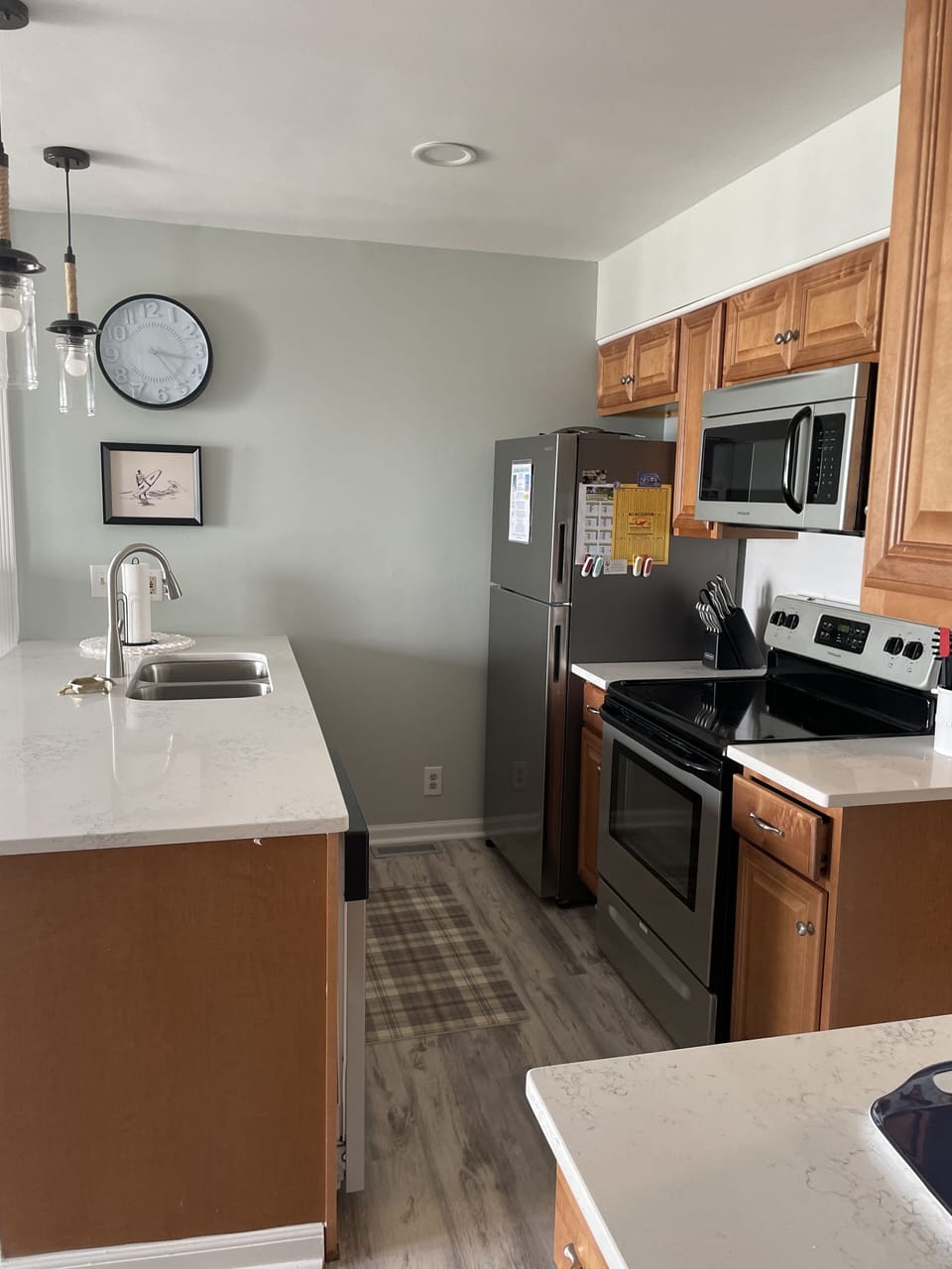 fully equipped kitchen-new quartz counters, sink, backsplash and lighting.