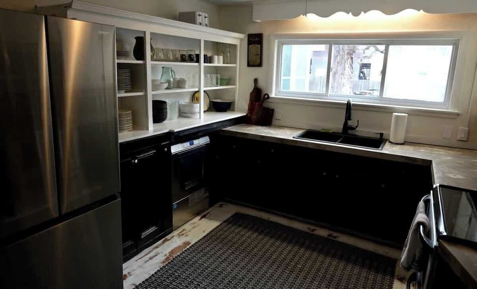 Our fully equipped kitchen is set to handle all the guests, from the proper amount of silverware to the commercial dishwasher which will do each load of dishes in 2 minutes! bring in the slight industrial feel with concrete counter tops, new fridge and coffee maker. Stove works and is great but is being updated in 20023 along with cabinets.