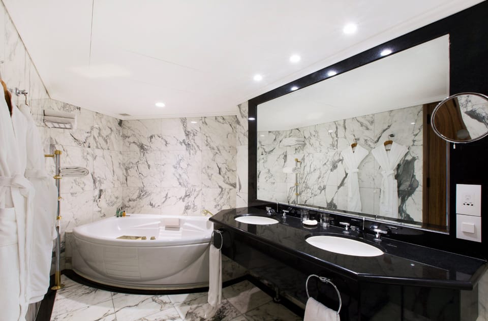 Executive Suite, 1 King Bed | Bathroom | Hair dryer, slippers, towels
