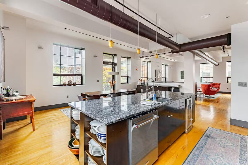 kitchen island features deep sink, KitchenAid dishwasher and beverage fridge