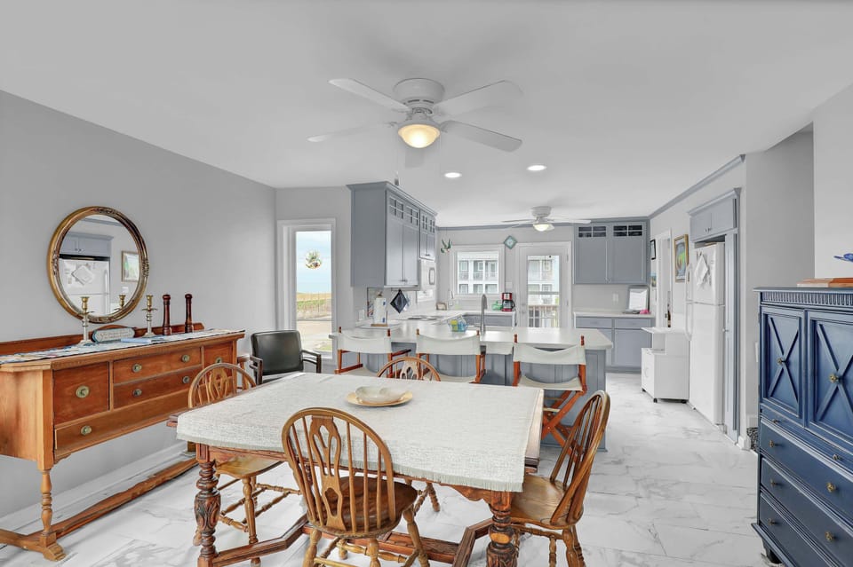 Step into relaxation and coastal charm as you enter the dining room of this townhouse - the ultimate seaside sanctuary.