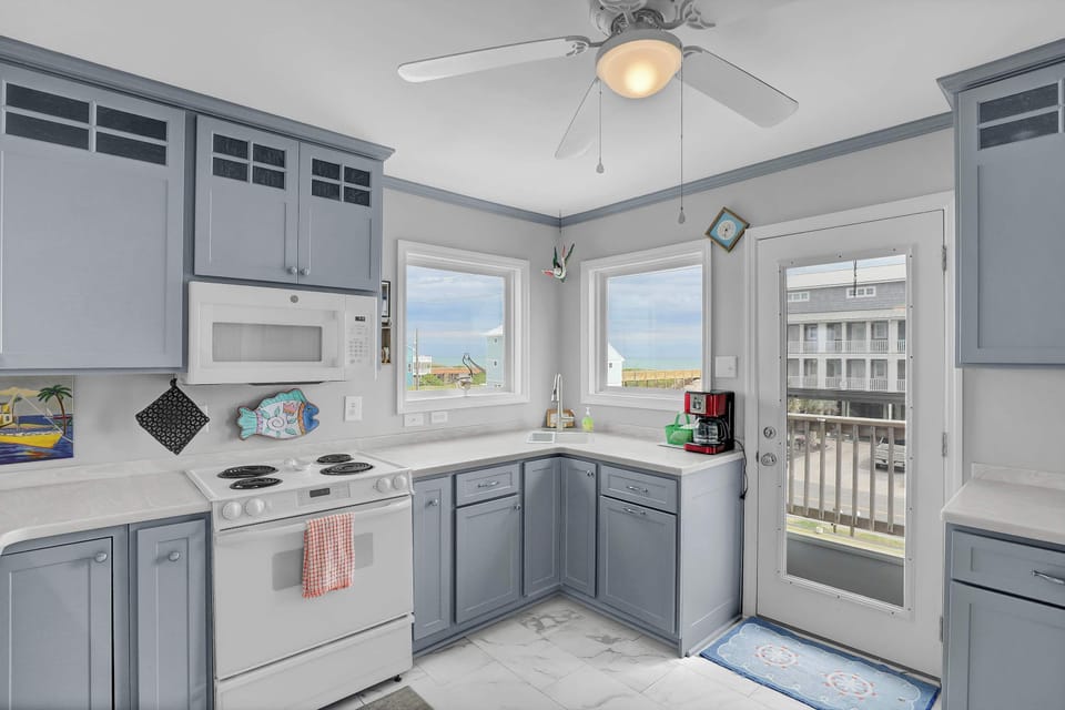 Indulge in coastal cuisine in this beautifully equipped kitchen, where culinary creativity meets seaside allure.