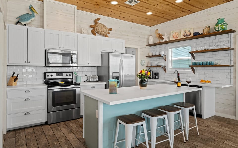 Kitchen — White Cabinets, Stainless Appliances & Blue Island with Bar Stools