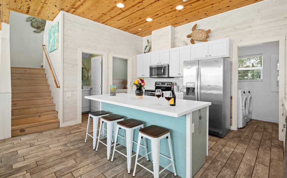 Kitchen Island — Bar Stools with Staircase & Coastal Wall Art