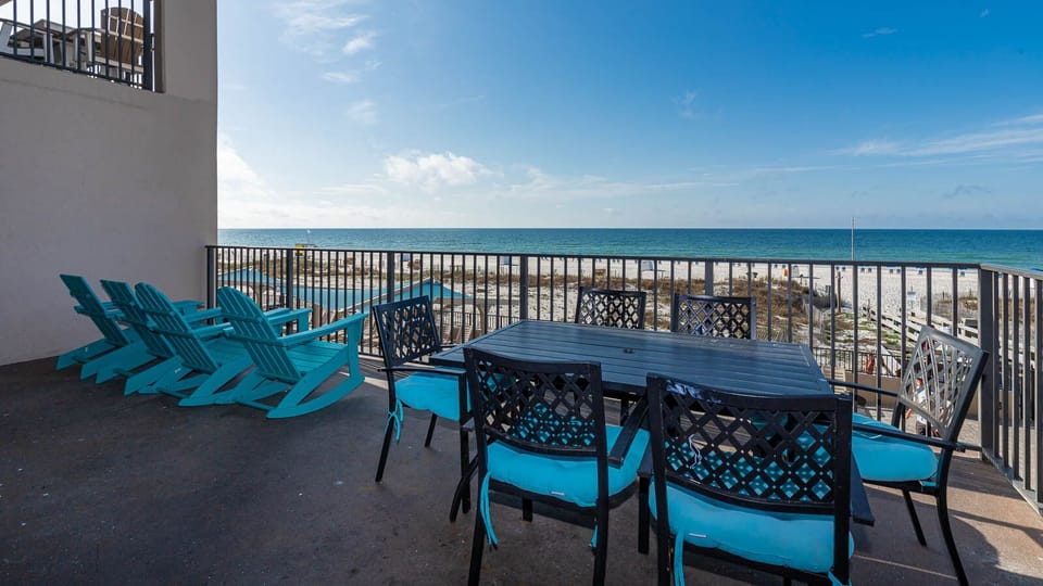 Relax on the extended balcony with colorful seating, perfect for enjoying the coastal views and fresh gulf air