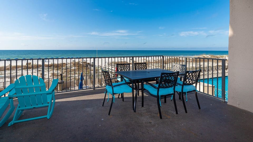 Enjoy meals or drinks on the spacious beachfront balcony with vibrant seating while taking in the beautiful coastal views