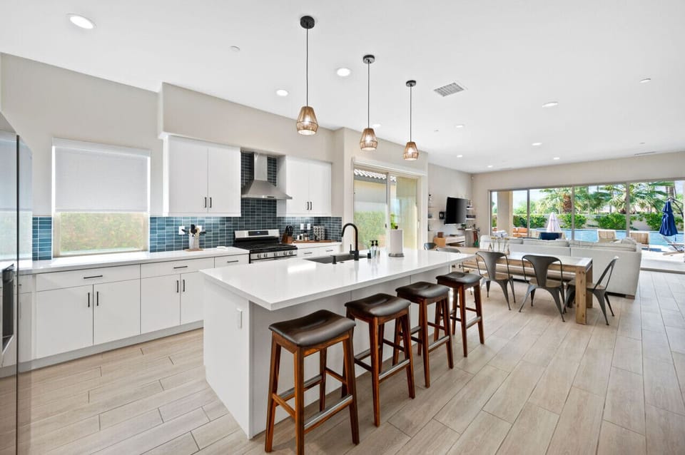 Modern kitchen w/ large island, bar seating & seamless flow into the dining area.