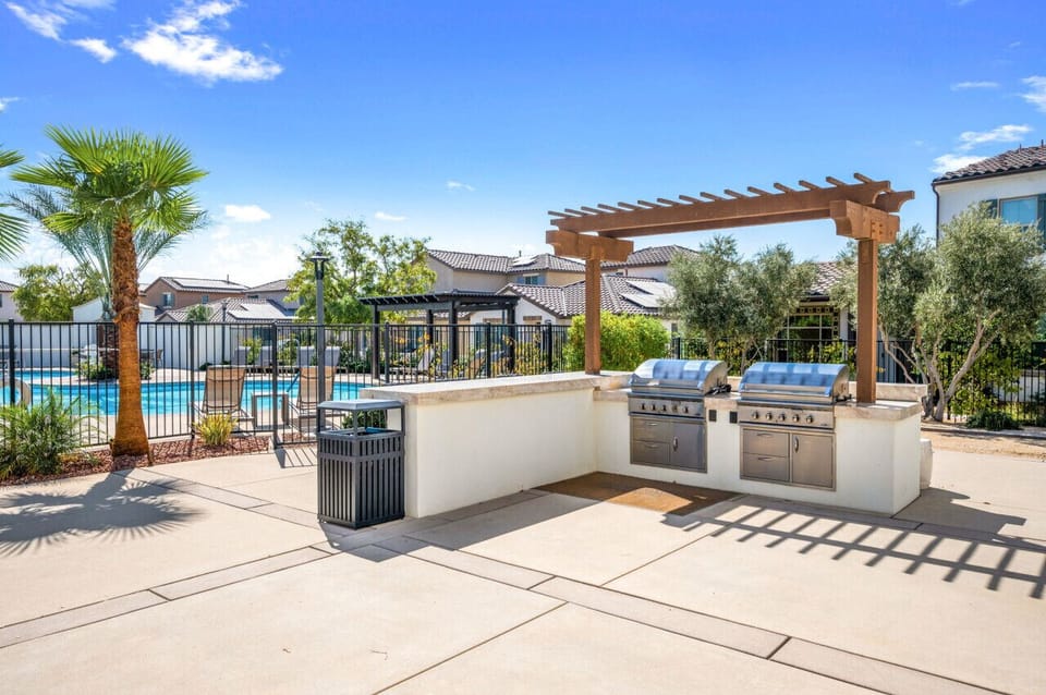 Outdoor community grill area w/ seating, perfect for casual gatherings.