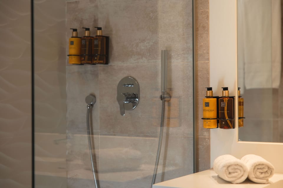 Shower, designer toiletries, hair dryer, bathrobes