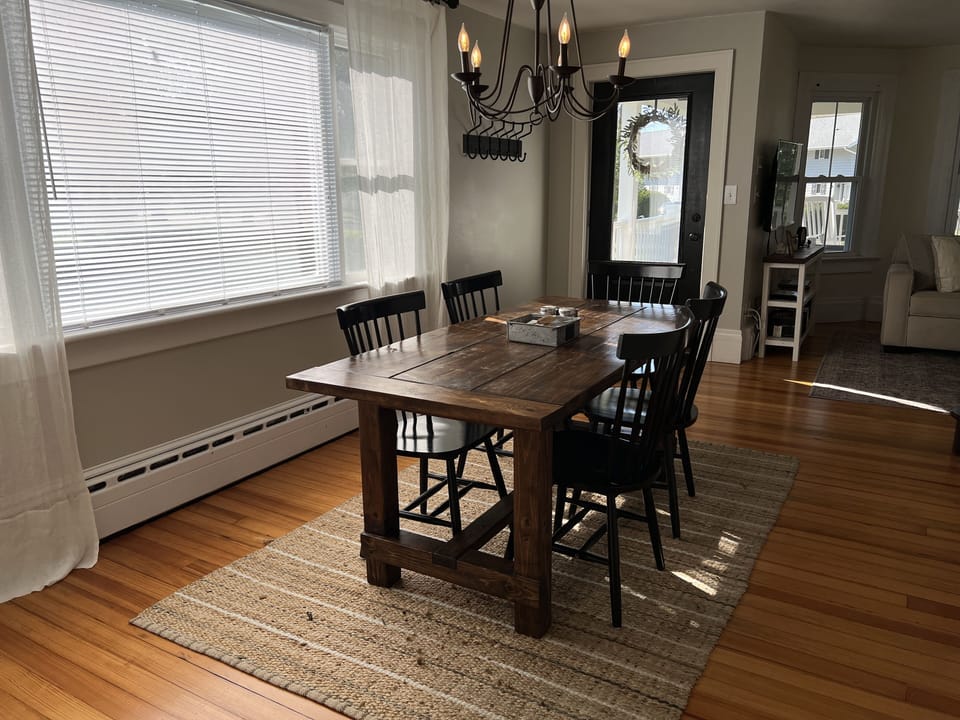 Dining room with table and chairs with chandelier above