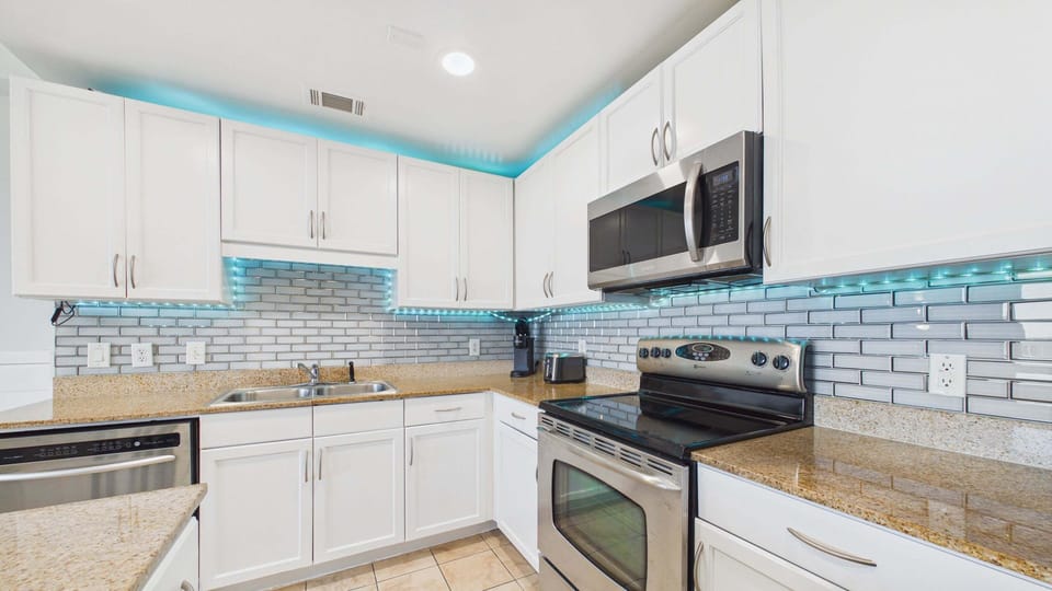 Full kitchen with stainless appliances, coffee essentials, and cooking essentials for your stay
