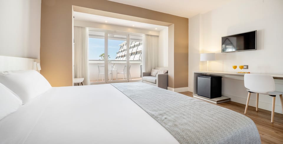 Family Quadruple Room | Minibar, in-room safe, desk, laptop workspace