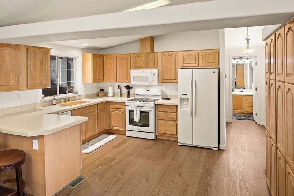 Spacious kitchen with stocked dish soap, dish detergent, trash bags and a new sponge.