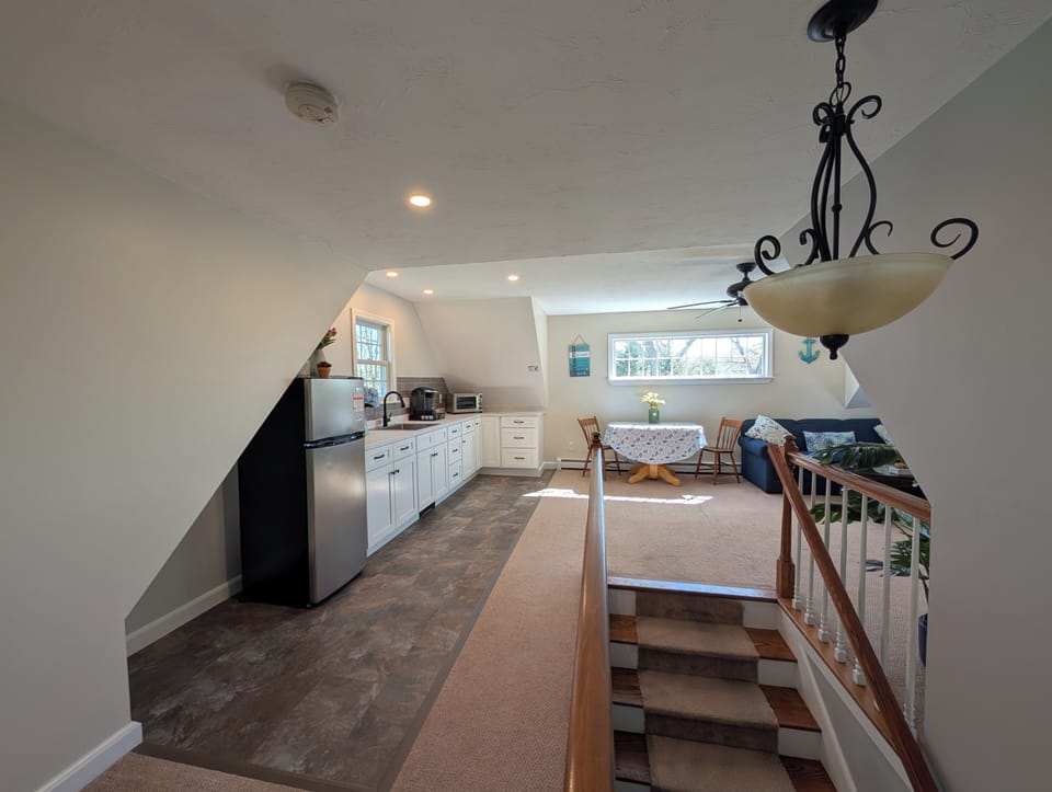 Walk up the stairs to a private living room and kitchenette