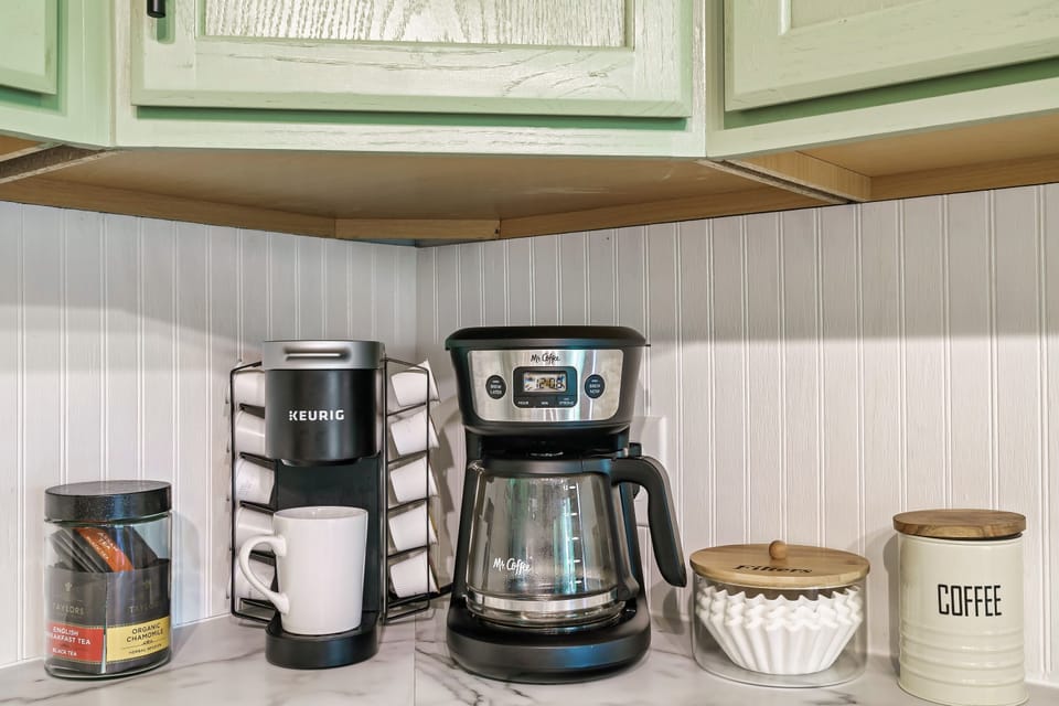 Drip coffee maker, single cup Keurig and a stock of assorted teas.