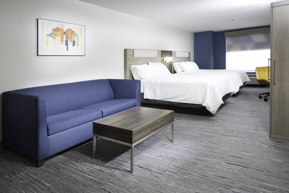 Suite, Multiple Beds | Laptop workspace, blackout drapes, iron/ironing board, free WiFi
