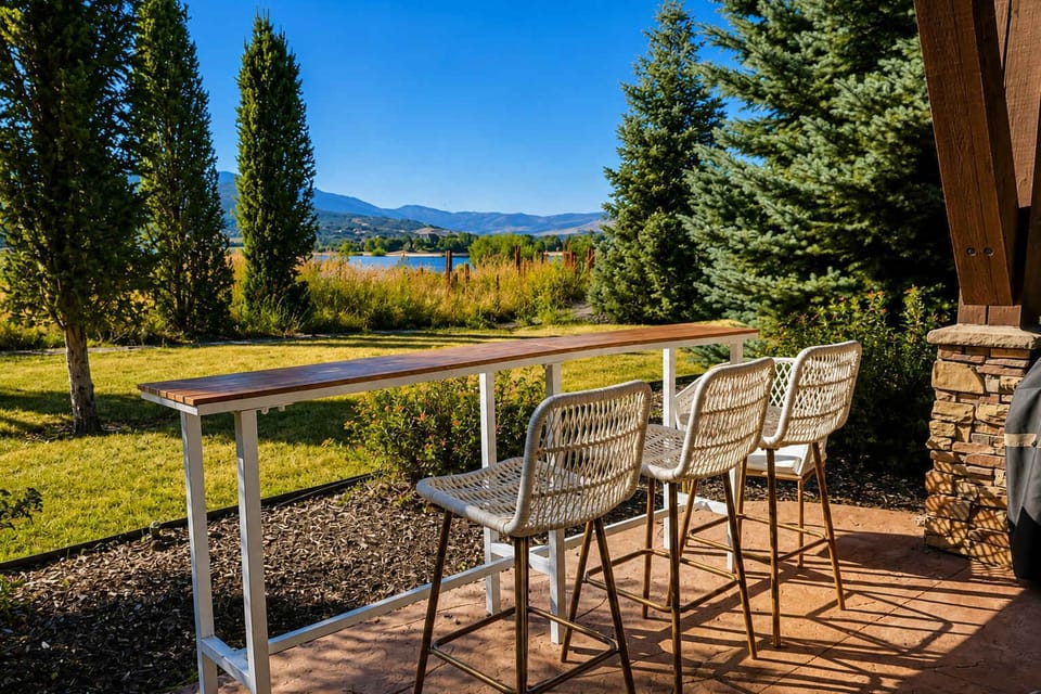 Relax at the patio bar table while taking in serene outdoor scenery.