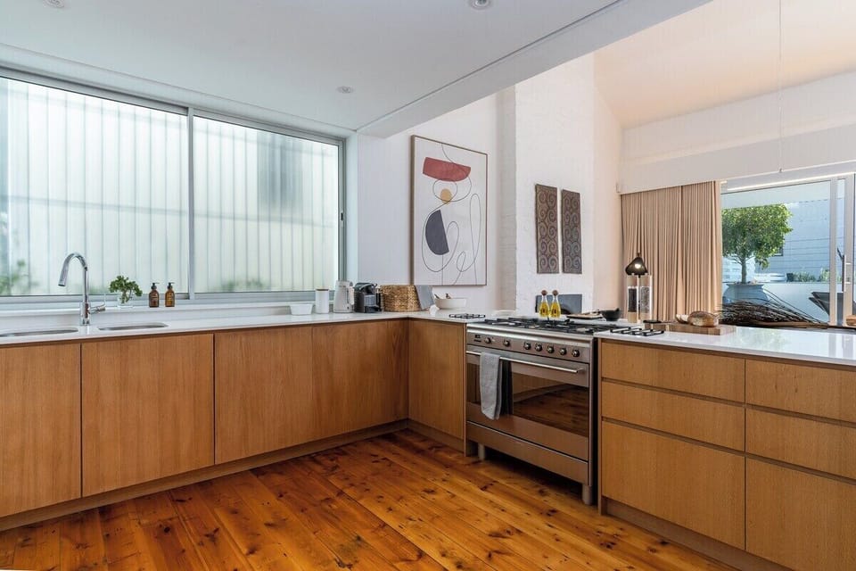 Kitchen with a gas stove, microwave, dishwasher, fridge, washing machine and dryer. 