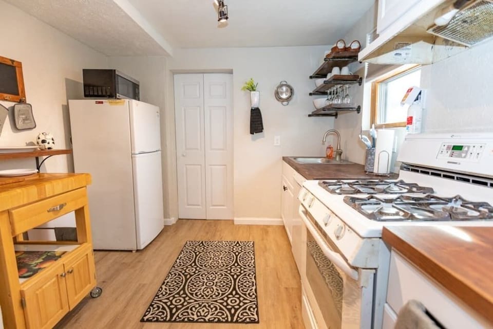 Another shot of the kitchen, which includes the fridge, microwave. 