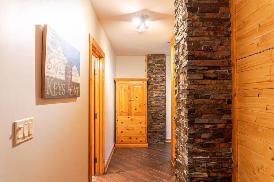 The view down the hallway is located off the front entryway. The hallway leads to the shared bathroom and two bedrooms.