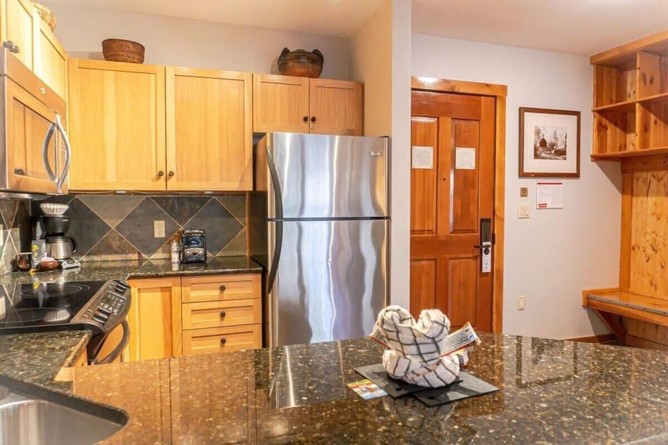 The well-laid-out kitchen is fully equipped with everything from stainless steel appliances to a coffee maker and blender making it convenient to put together a delicious meal during your stay.