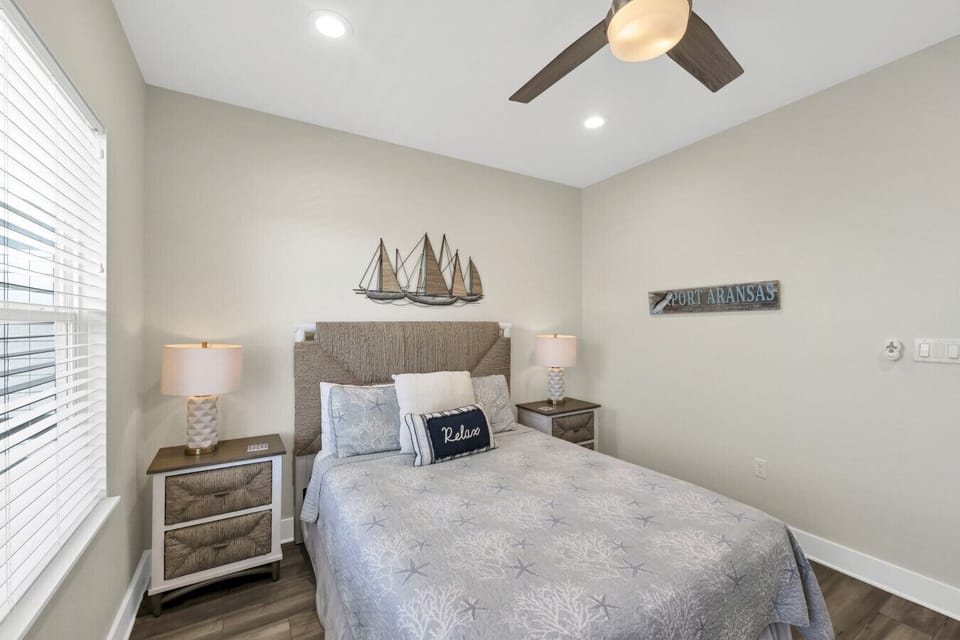 Inviting coastal guest bedroom with a comfortable bed, soft linens, and calming beach-inspired décor.