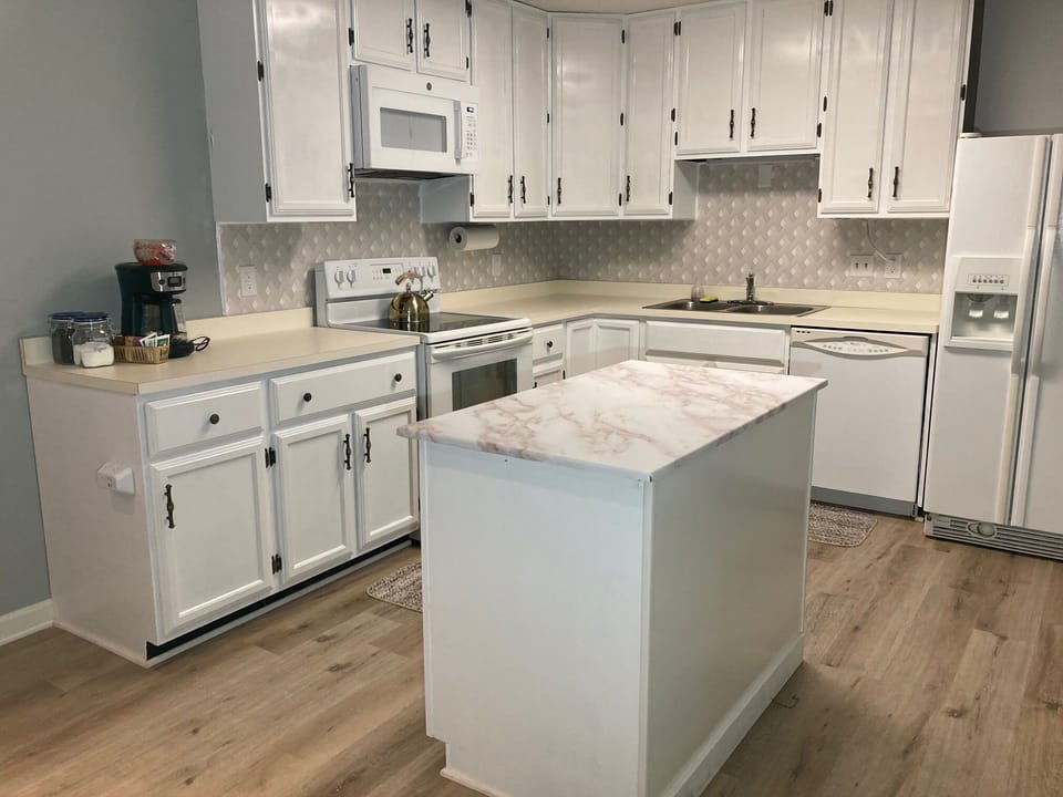 Kitchen with a fully stocked kitchen with serving set, utensils and cook ware