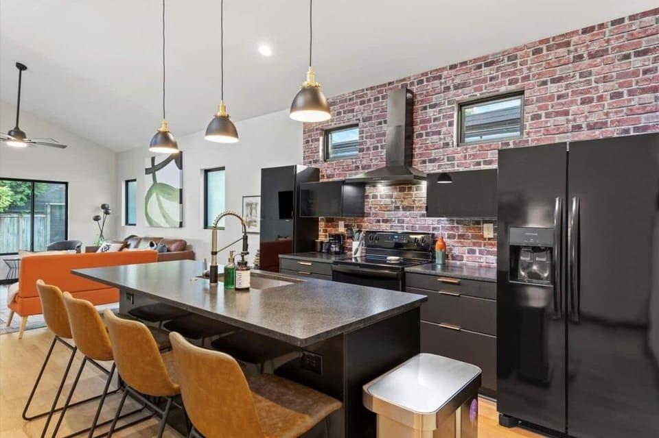 Chef's kitchen w/ leathered-granite island & countertops. 