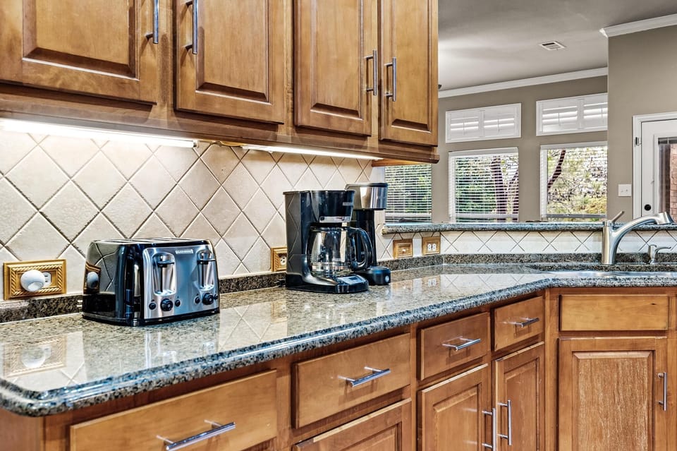 Beautiful open concept kitchen/dining/living spilling into gorgeous back yard 