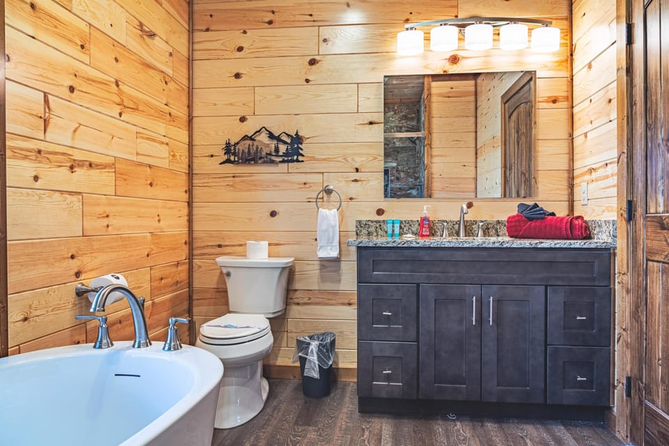Main level full bathroom with soaker tub and custom tile shower. 