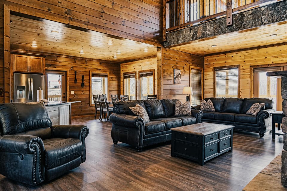 Open living area boasts gas fireplace, sleeper sofa, and smart TV.
