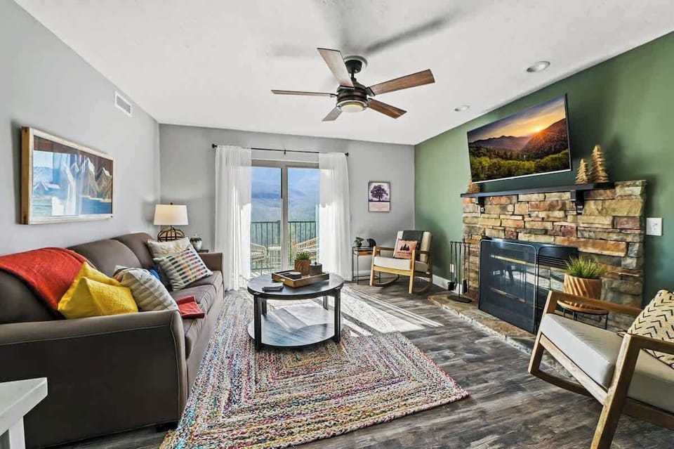 1st Living Room View w/ Green Accent Wall, Wood-burning Fireplace & Private Patio Entrance