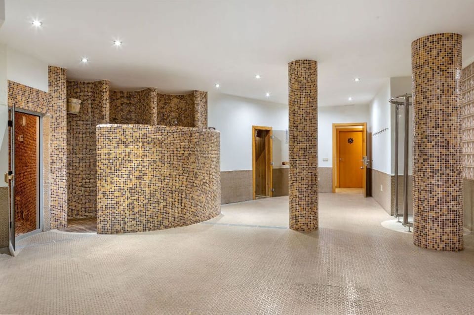 Indoor relaxation pool with hydrotherapy features, offering a tranquil spa experience.