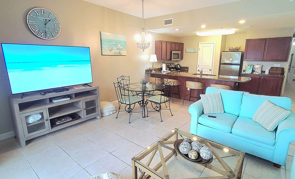 Living Area with Dining Table and Bar Seating with Open Kitchen