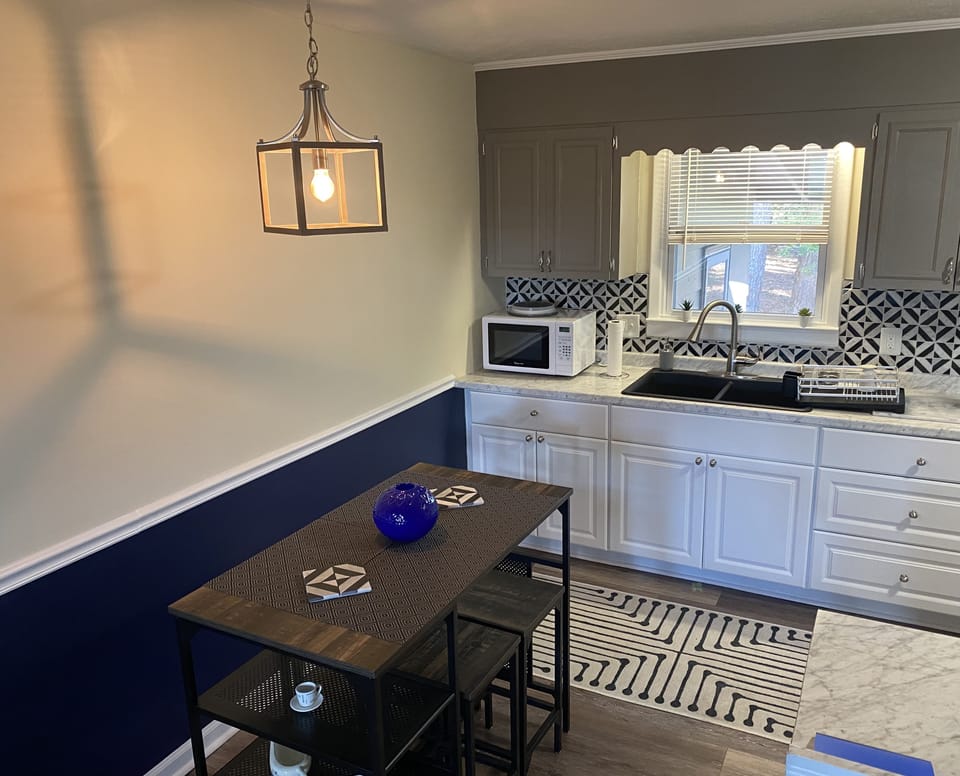Dining table to enjoy your meals and a microwave to heat your leftovers.
