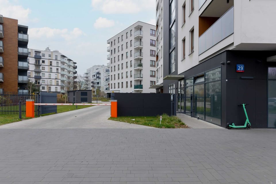 The apartment building with a well-maintained entrance surrounded by landscaped greenery.