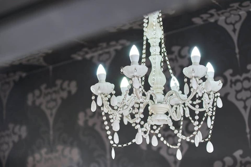 A close-up shot of the ornate chandelier, enhancing the luxurious ambiance of the apartment.