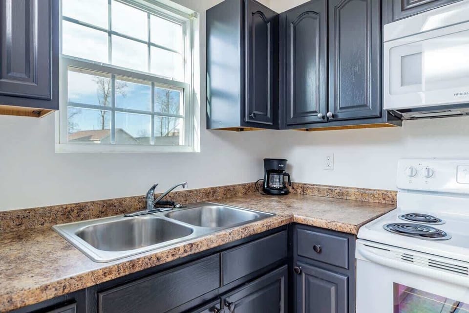 Cooking just got a whole lot easier! This kitchen boasts a double sink, microwave, and stove, making it the ultimate space for meal prep. What’s on your menu today?