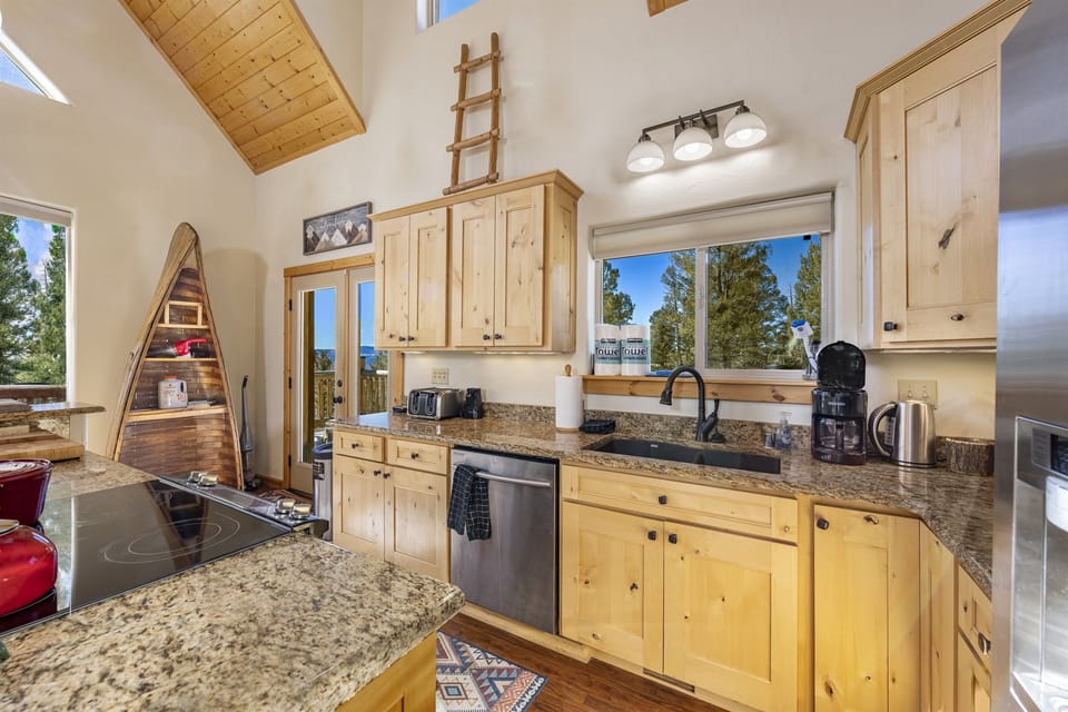 The fully stocked kitchen with all stainless appliances