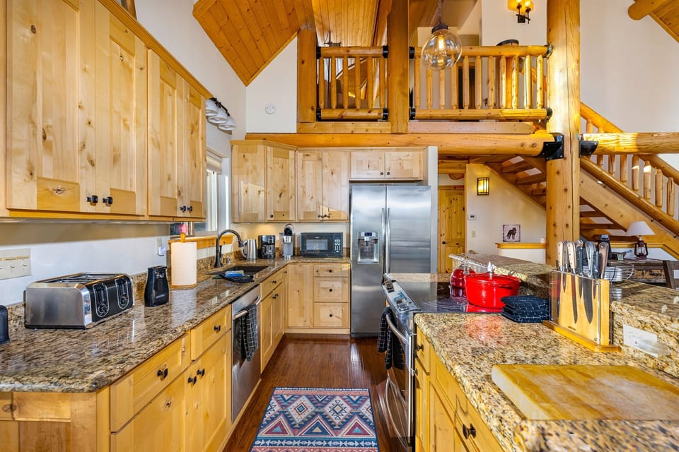 The fully stocked kitchen with all stainless appliances