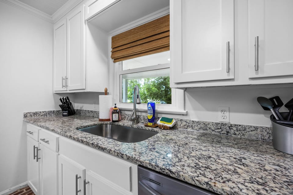 Fully stocked kitchen includes paper towels, sponge, dish soap, dishwasher pods,