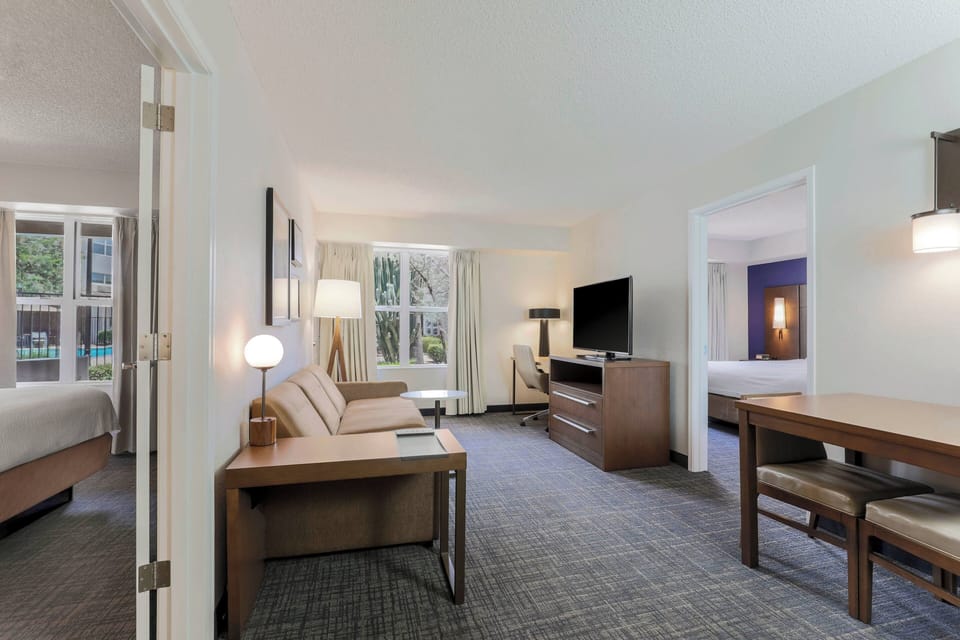 Premium bedding, desk, laptop workspace, blackout drapes