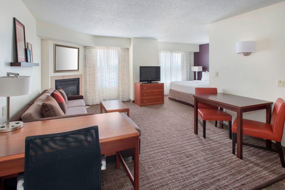 Premium bedding, desk, laptop workspace, blackout drapes