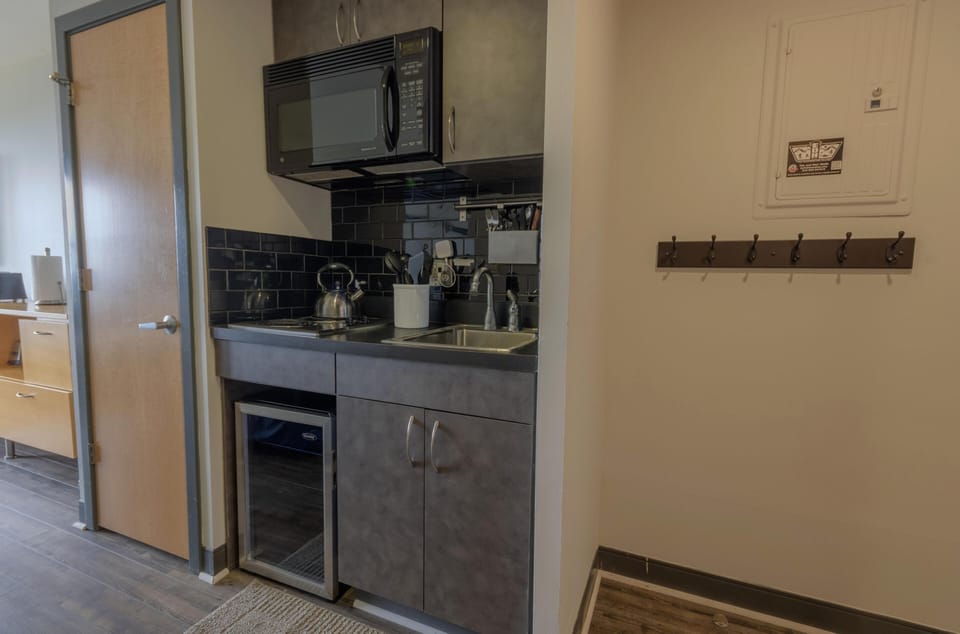 The kitchenette comes with a microwave, fridge (please note this is a mini fridge), a two-burner range, and has all the basics you'll need to prepare, cook, and serve a delicious meal.